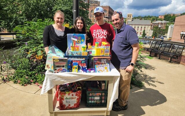Leah Ackner, Meira Loring, Zev Loring and Jonathan Loring stand outside UPMC Mercy with art supplies Meira donated in honor of her bat mitzvah. Photo by Adam Reinherz