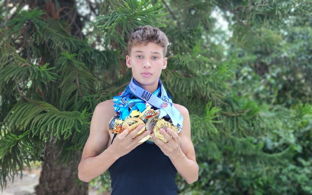 JJ Harel shows off his AAU medals. (Photo by Lucy Harel)