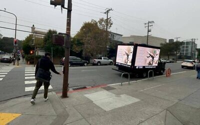 A truck emblazoned with an image of Adolf Hitler and the phrase "All in favor of banning Jews, raise your right hand," drove through Berkeley, Calif., October 2022, in response to a controversy involving several UC Berkeley Law student groups resolving to bar "Zionist" speakers. (Courtesy of Accuracy in Media)