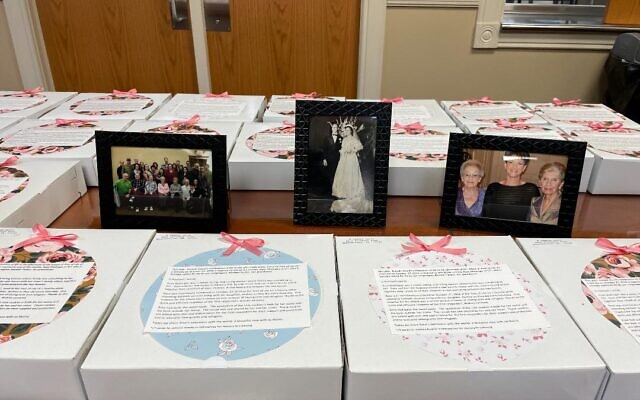 Boxes waiting to be delivered surround photos of Rose Mallinger and her family. Photo by Kim Rullo