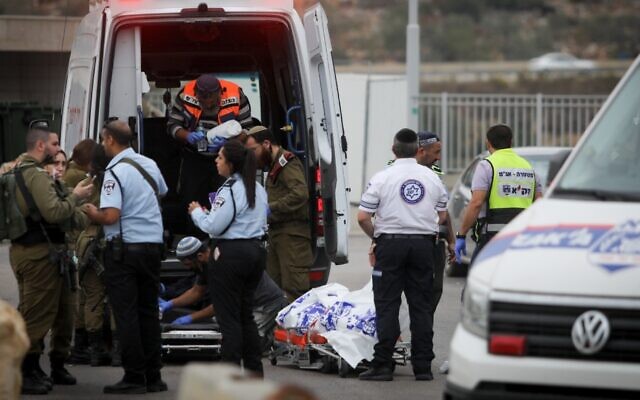 Medics remove the body of a man murdered in a stabbing attack earlier, outside Ariel, in the West Bank, on Nov. 15 (Photo via JTA)