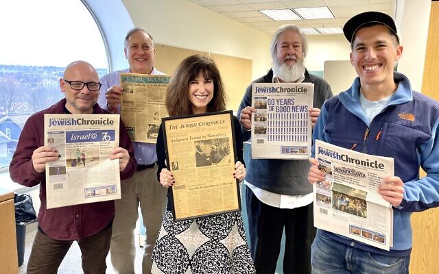 The staff of the Pittsburgh Jewish Chronicle holds some memorable issues of the paper. From left: Staff Writer David Rullo; Publisher and CEO Jim Busis; Editor Toby Tabachnick; Senior Sales Associate Phil Durler; Staff Writer Adam Reinherz  (Photo by Kim Rullo)