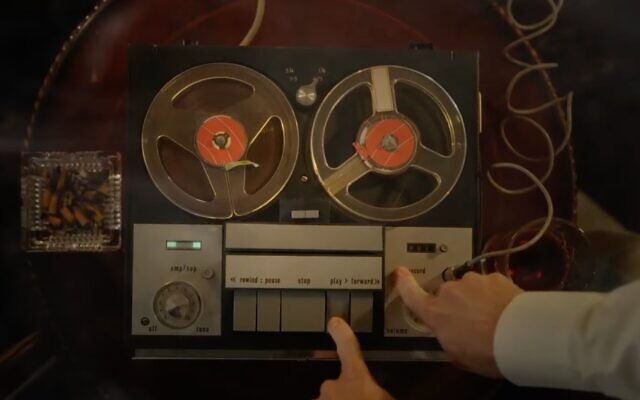 In a scene from "The Devil's Confession," someone sets up the recorder to listen to a tape. (Screenshot via YouTube)