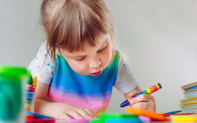 Student colors with crayon. Photo by lithiumcloud via iStock