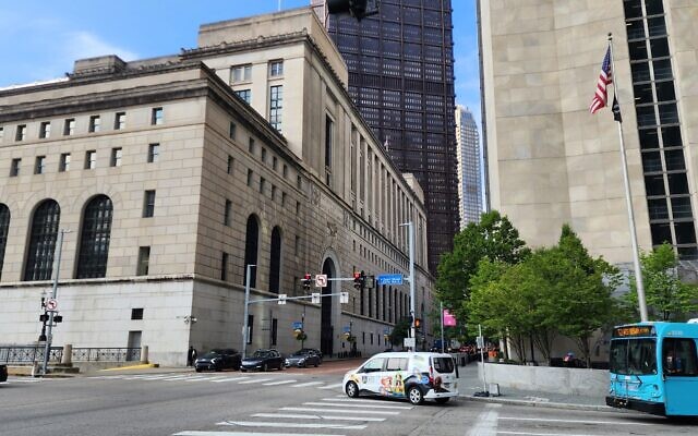 A flag flies across the street from the Joseph F. Weis, Jr. U.S. Courthouse on July 13. (Photo by Adam Reinherz)