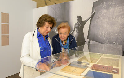 Lydia Barenholz and Ruth Melcer, who attended Munich's post-war Hebrew high school together, are shown with some of the objects they contributed to the new exhibit, "Munich Displaced. The Surviving Remnant." (Daniel Schvarcz)