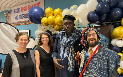 Rebecca Jacobson (left), Emily Loeb, Alain Tamonoche and Noah Schoen pose at a reception honoring the Bamileke king of Bafoussam during his visit to Pittsburgh. Photo by Rocky Schoen