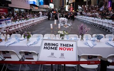 An empty Shabbat table symbolizing the over 200 hostages held by Hamas in Gaza, in Times Square, New York City, October 27, 2023. (Luke Tress)