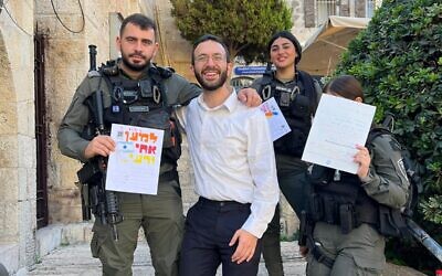 Rabbi Yitzi Genack, center, delivers cards to Israeli soldiers during a mission to Israel last month. (Photo courtesy of Rabbi Yitzi Genack)