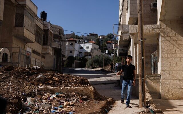 A boy walks around a road block placed by settlers, in Howard, West Bank, Nov. 04, 2023. (Dan Kitwood/Getty Images)