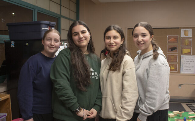 From left: Production heads Fraidy Rosenblum, Rivka Presman, Shayna Backman, and Esther Rosenblum pose for a photo inside Yeshiva Girls School on a rehearsal night. (Photo by Abigail Hakas)