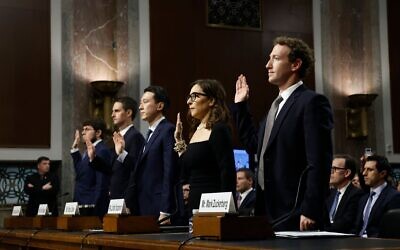 From left to right, Jason Citron, CEO of Discord, Evan Spiegel, CEO of Snap, Shou Zi Chew, CEO of TikTok, Linda Yaccarino, CEO of X, and Mark Zuckerberg, CEO of Meta are sworn-in as they testify before the Senate Judiciary Committee at the Dirksen Senate Office Building on January 31, 2024 in Washington, DC. The committee heard testimony from the heads of the largest tech firms on the dangers of child sexual exploitation on social media. (Anna Moneymaker/Getty Images)