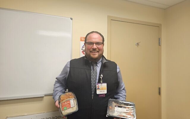 UPMC Children’s Hospital Senior Director of Food and Nutrition Evan Isenberg holds two items from the hospital’s expanded kosher and halal offerings. (Photo by David Rullo)