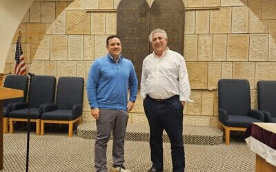 Rabbi Aaron Bisno stands with Temple Ohav Shalom President Aaron Brauser in front of the congregation's ark. (Photo by David Rullo)