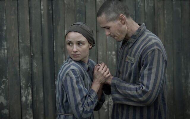 Jonah Hauer-King as Lali Sokolov and Anna Próchniak as Gita Furman embrace in Auschwitz in the first episode of Peacock's "The Tattooist of Auschwitz." (Martin Mlaka/Sky UK via JTA)