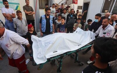 Palestinian workers transfer the bodies of the volunteers from the World Central Kitchen who were killed from an Israeli airstrike, from Al-Najjar Hospital, to Rafah crossing, in the southern Gaza Strip, April 3, 2024. (Mohammed/Flash90)