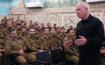 Defense Minister Yoav Gallant speaks to soldiers drafting into the IDF's Armored and Combat Engineering Corps at the Tel Hashomer military base, central Israel, April 8, 2024. (Ariel Hermoni/Defense Ministry)