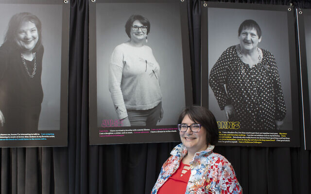 Julie Arnheim poses with her portrait at The Branch’s “Breaking Down the Walls” event on May 16. (Photo by Abigail Hakas)
