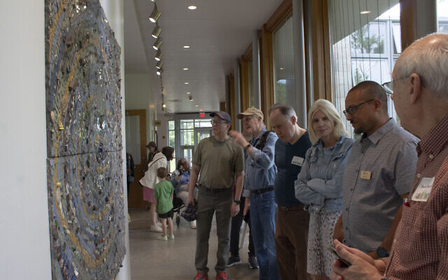 Community members view the recently installed mosaic mural at the Frick Environmental Center (Photo by Abigail Hakas)