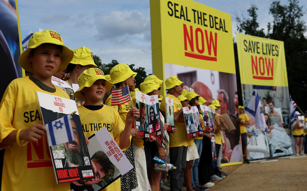 People hold pictures of Israeli hostages during a vigil on the National Mall, July 23, 2024. (Justin Sullivan/Getty Images) People hold pictures of Israeli hostages during a vigil on the National Mall, July 23, 2024. (Justin Sullivan/Getty Images)