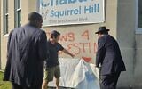David Knoll points out the red inverted triangle spray painted on Chabad of Squirrel Hill’s building in July 2024 (Photo by David Rullo)