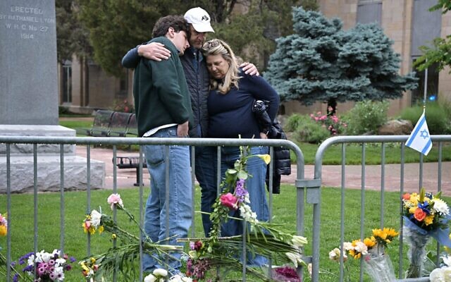 Isaac Dechtman of Denver and his parents Evan and Jennifer comfort each other at the Boulder County Courthouse on Pearl Street in Boulder, Colorado, on June 3, 2025, two days after 12 people marching to raise awareness for Israeli hostages in Gaza were injured in a "targeted act of violence" by a man wielding incendiary devices. (Hyoung Chang/The Denver Post)