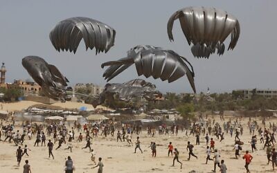 Gazans flock to the area where humanitarian aid is dropped from the air in Deir al Balah on Aug. 19, 2025. (Mohammed Nassar/Anadolu via Getty Images)