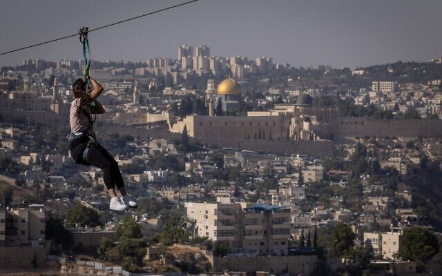 A girl rides a 750-meter extreme zipline in Jerusalem from the Armon Hanatziv Promenade to the Peace Forest, Aug. 20, 2024. (Photo by Chaim Goldberg/Flash90, via JNS)