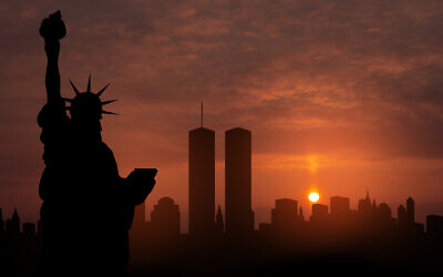 New York skyline silhouette with Twin Towers and The Statue of Liberty at sunset. 09.11.2001 American Patriot Day banner (Photo by vadimrysev via iStock)