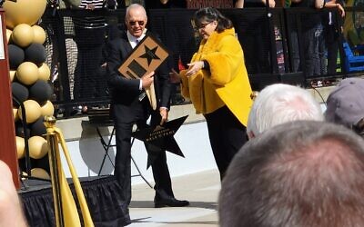 Actor Michael Keaton and Pittsburgh Walk of Fame Executive Director Nancy Polinsky Johnson celebrate during an Oct. 20 event at the Strip District Terminal. (Photo by Adam Reinherz)