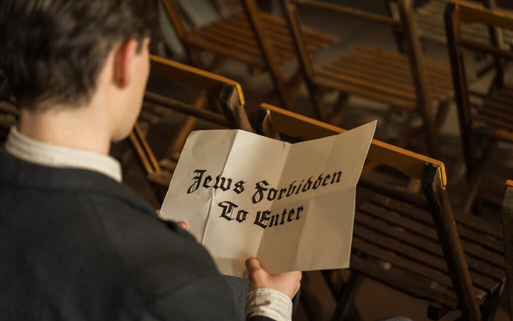 Ewan Horrocks as Helmuth Hubener holds a sign in a still from 'Truth and Treason.' (Courtesy Angel Studios) Ewan Horrocks as Helmuth Hubener holds a sign in a still from 'Truth and Treason.' (Courtesy Angel Studios)