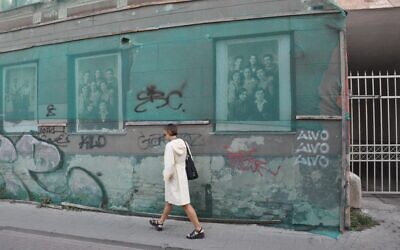 A pedestrian passes a building in Vilnius, Lithuania, that formerly housed the ghetto library. (Photo by Adam Reinherz)