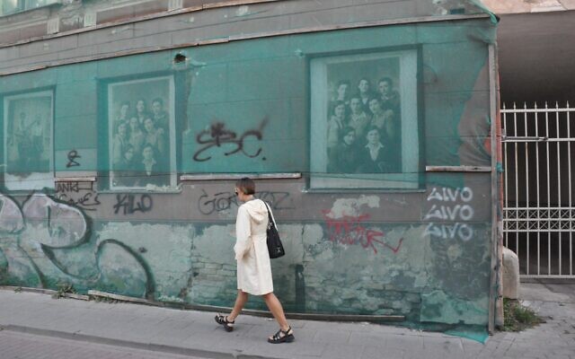 A pedestrian passes a building in Vilnius, Lithuania, that formerly housed the ghetto library. (Photo by Adam Reinherz) A pedestrian passes a building in Vilnius, Lithuania, that formerly housed the ghetto library. (Photo by Adam Reinherz)