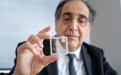 Dr. José-Alain Sahel holds the PRIMA implant. (Photo courtesy of UPMC)