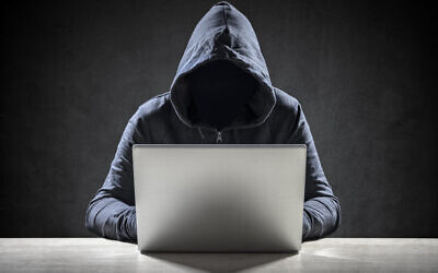 Computer hacker stealing data from a laptop (Photo by BrianAJackson via iStock)