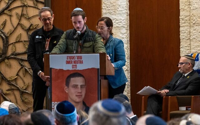 Ronen and Orna Neutra, with their son Daniel, speak at the Midway Jewish Center on Long Island during a memorial service for their son, Omer Neutra, an Israeli American soldier killed on Oct. 7, in Syosset, New York, Dec. 3, 2024. (Spencer Platt/Getty Images)
