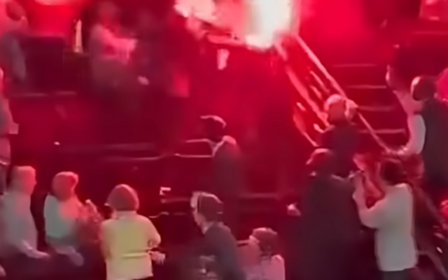 Pro-Palestinian protesters lit flares that interrupted a performance of the Israel Philharmonic in Paris on Nov. 6, 2025. (Screenshot)