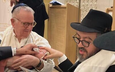 Rabbi Eli Schlanger, at right, participates in his son's bris several weeks before his murder at Bondi Beach on Dec. 14, 2025. (Facebook)