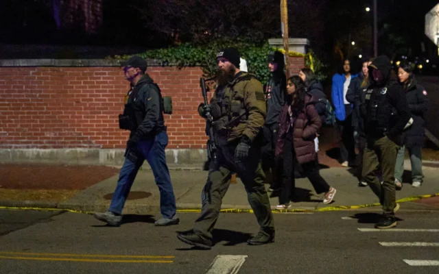 Law enforcement officers escort students near the Barus & Holley engineering building at Brown University campus in Providence, Rhode Island, on Dec. 13, 2025. (Photo by Bing Guan / AFP via Getty Images, via JNS)
