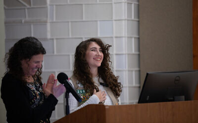 Emily Loeb and Lily Sassani unveil the new Holocaust Girl Scout patch on Dec. 7 (Photo by Melanie Wieland)