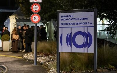 Delegates leave the headquarters of the European Broadcasting Union (EBU) after the first day of a two-day general assembly of the EBU, which organizes the Eurovision Song Contest, in Geneva, on December 4, 2025. (Fabrice COFFRINI / AFP)