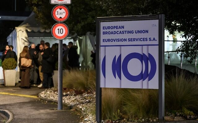 Delegates leave the headquarters of the European Broadcasting Union (EBU) after the first day of a two-day general assembly of the EBU, which organizes the Eurovision Song Contest, in Geneva, on December 4, 2025. (Fabrice COFFRINI / AFP)
