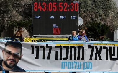 A photograph shows a banner bearing a portrait Ran Gvili, the last hostage held in Gaza, the day after his remains were brought home by Israeli forces, in Hostage Square in Tel Aviv on Jan. 27, 2026. (Jack GUEZ / AFP)