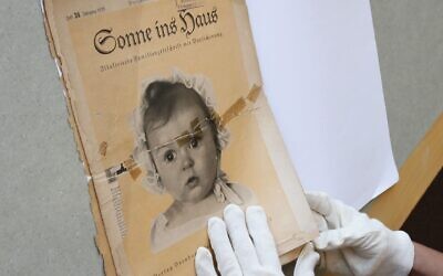 At the archives of the Yad Vashem Holocaust memorial museum, the front page of the original issue of the Nazi family magazine "Sonnie ins Hous" (Sunshine in the House) shows baby Hessy Taft as the ideal German Aryan baby.     (GALI TIBBON/AFP via Getty Images)