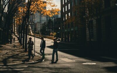 Individuals cross a downtown street in Pittsburgh. (Photo by Teagan Hunt via Pexels)