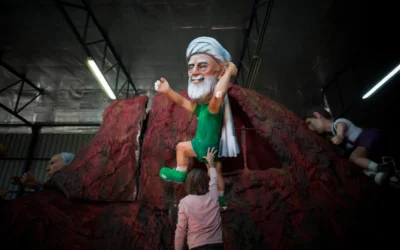 An Israeli worker carries a figure depicting Iran's Supreme Leader Ali Khamenei as part of the preparations for the Israeli annual parade of the holiday of Purim, in a set design factory near Kfar Saba, Israel, Feb. 10, 2014. (Credit: Yonatan Sindel/Flash90, via JNS)
