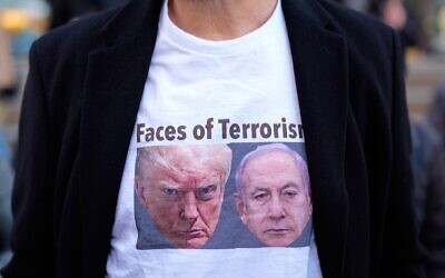 A person wears a t-shirt with images of U.S. President Donald Trump and Israeli Prime Minister Benjamin Netanyahu during a protest in New York against the war in Iran on March 2, 2026. (Adam Gray/Getty Images)