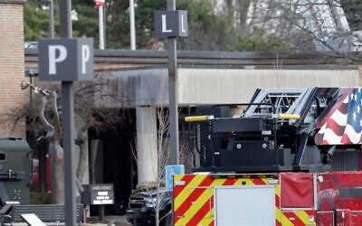 Law enforcement remain on site at the Temple Israel synagogue in West Bloomfield, Michigan, a Detroit suburb, on March 12, 2026, after an assailant drove a vehicle into the building. (Photo by Jeff Kowalsky/AFP via Getty Images)