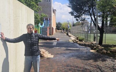 Kim Salzman at the bomb shelter that protected children playing soccer in Karmiel. She visited it the day after the incident and points out the soccer field and the donor sign with Federation’s logo. (Photo courtesy of Kim Salzman)
