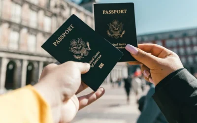 Two people holding up U.S. passports (Credit: Spencer Davis/Pexels)